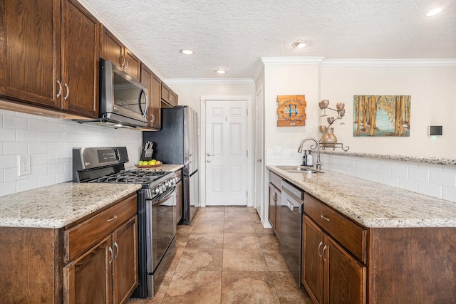 kitchen with light stone counters, ornamental molding, appliances with stainless steel finishes, and sink