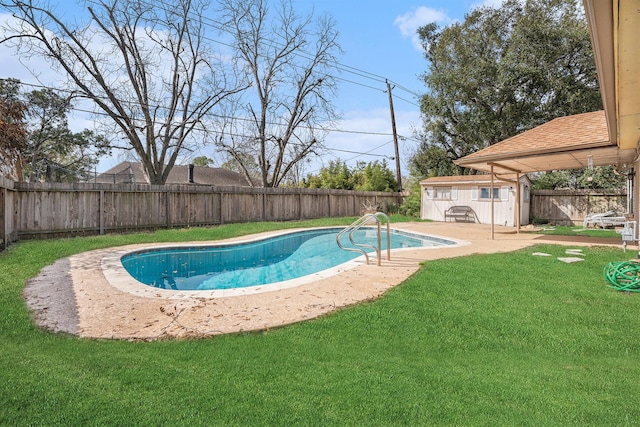 view of swimming pool featuring a lawn and a storage unit