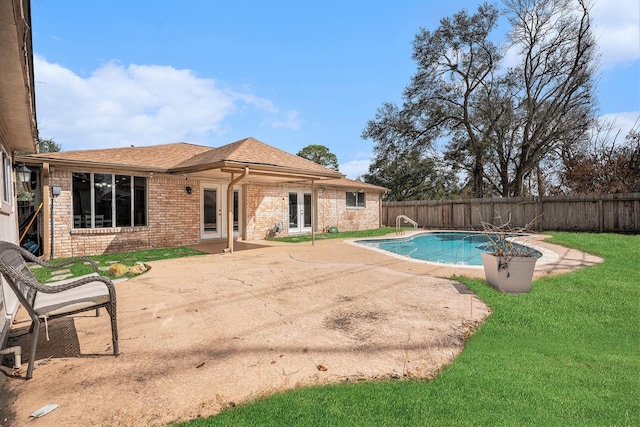 view of pool featuring a patio area and a lawn