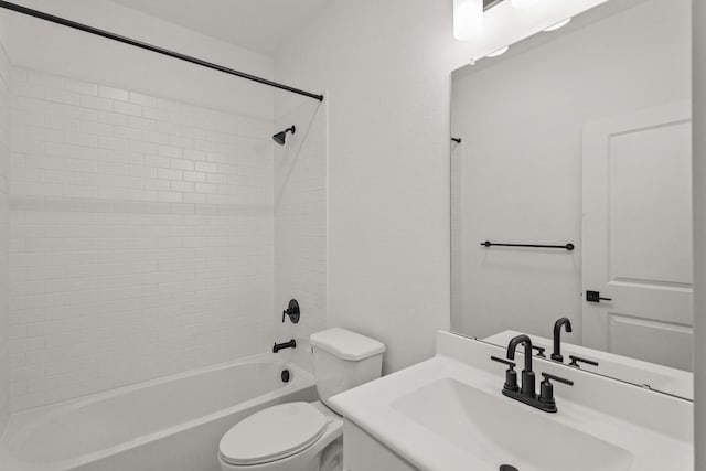 full bathroom featuring tiled shower / bath, vanity, and toilet