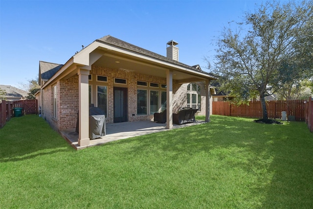 back of property featuring a lawn and a patio