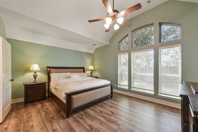 bedroom featuring dark hardwood / wood-style flooring, vaulted ceiling, and ceiling fan