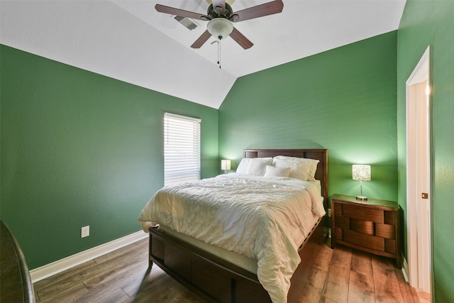 bedroom with dark wood-type flooring, ceiling fan, and vaulted ceiling