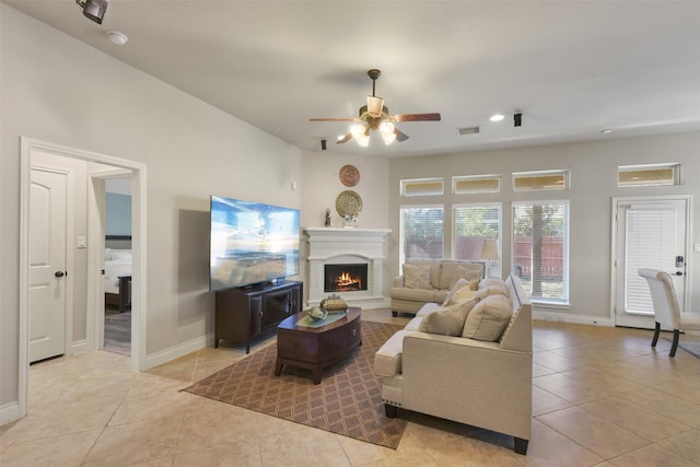 tiled living room with ceiling fan