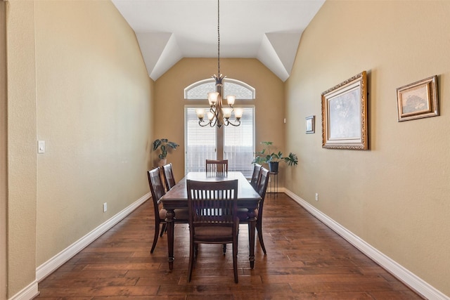 dining room featuring dark hardwood / wood-style floors, vaulted ceiling, and a notable chandelier