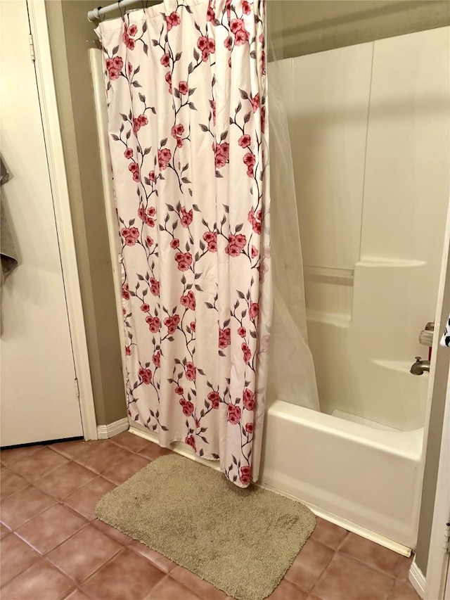 bathroom with tile patterned flooring and shower / bathtub combination with curtain