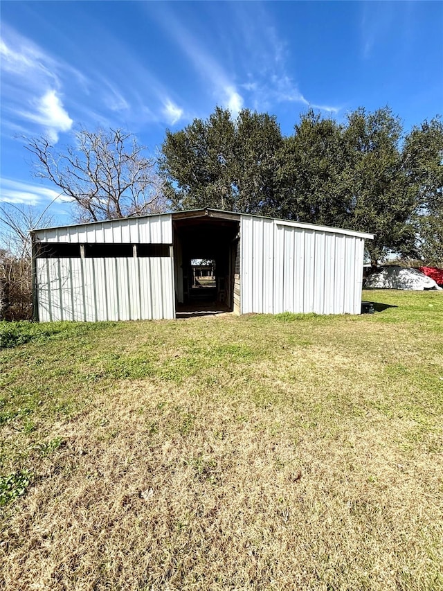 view of outbuilding with a lawn