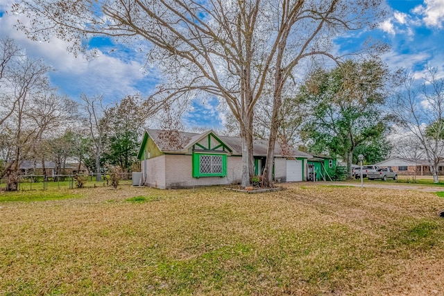 view of front of home featuring a garage and a front lawn