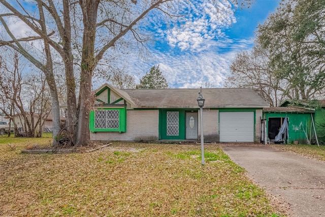 ranch-style home featuring a garage and a front lawn