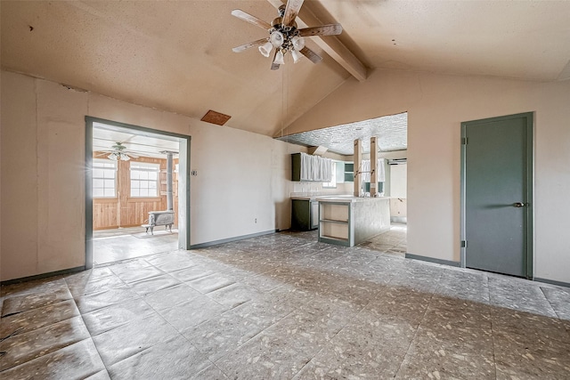 unfurnished living room featuring ceiling fan, high vaulted ceiling, and beam ceiling