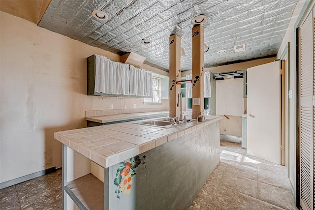 kitchen featuring sink and tile counters