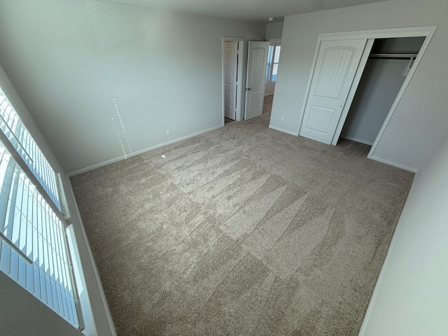 unfurnished bedroom with carpet floors and a closet