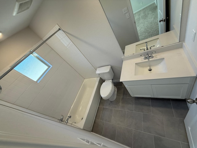 bathroom featuring vanity, a bathtub, tile patterned floors, and toilet