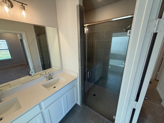 bathroom featuring vanity, tile patterned flooring, and a shower with door