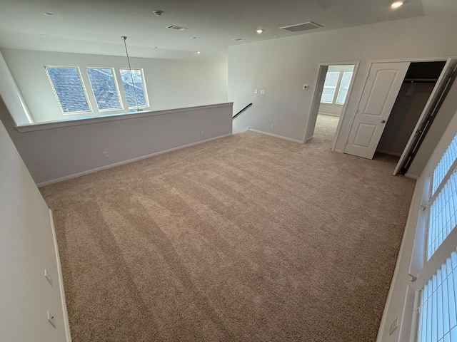 unfurnished room with light colored carpet