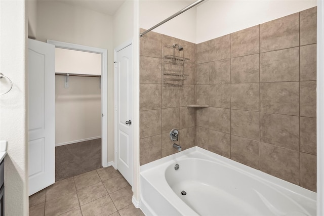 bathroom with tiled shower / bath and tile patterned flooring