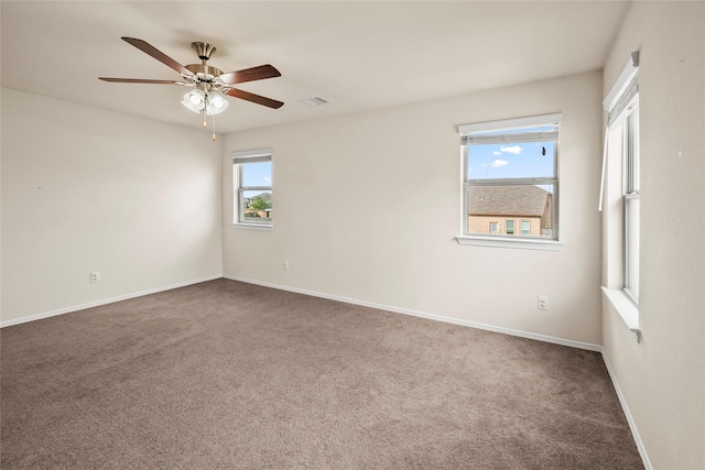 unfurnished room featuring carpet, a wealth of natural light, and ceiling fan