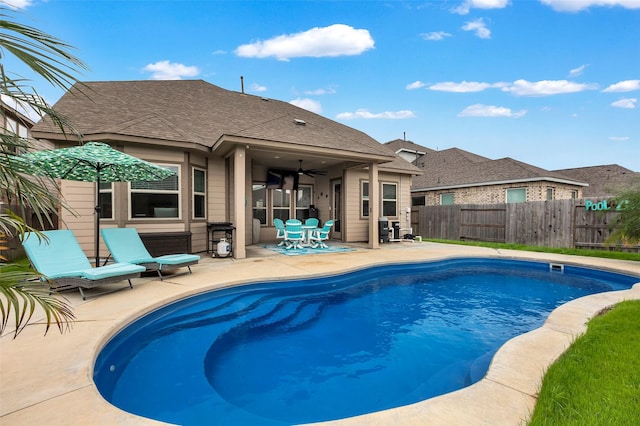 view of pool with ceiling fan and a patio