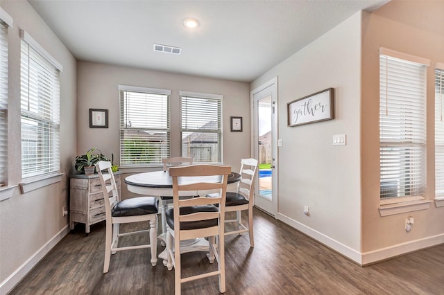 dining space with dark wood-type flooring