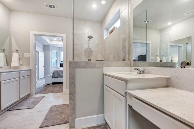 bathroom with vanity, tile patterned floors, and a shower