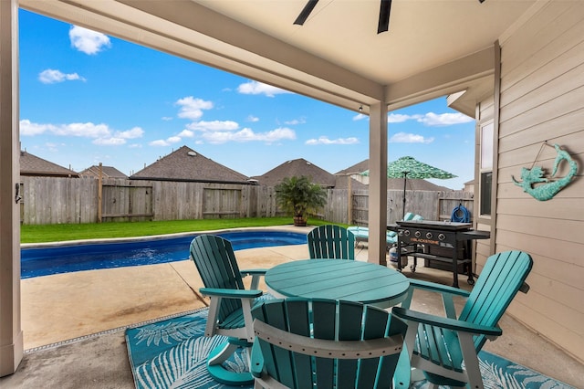 view of patio / terrace featuring ceiling fan and a fenced in pool