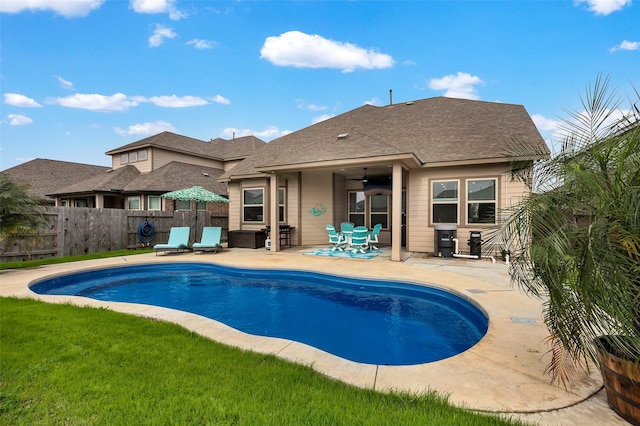 view of swimming pool featuring a patio and ceiling fan