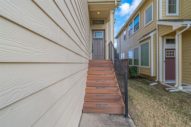 view of exterior entry featuring a yard