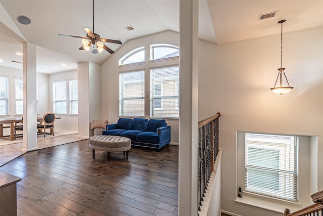 living room featuring ceiling fan, lofted ceiling, and dark hardwood / wood-style floors