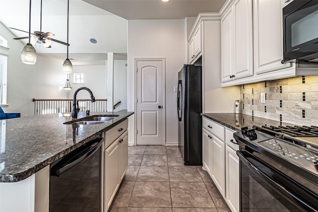 kitchen featuring sink, white cabinetry, hanging light fixtures, a kitchen island with sink, and black appliances