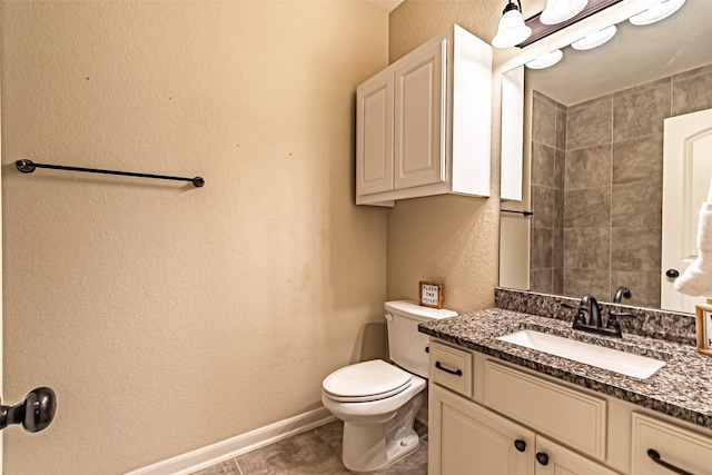 bathroom featuring vanity, tile patterned flooring, and toilet