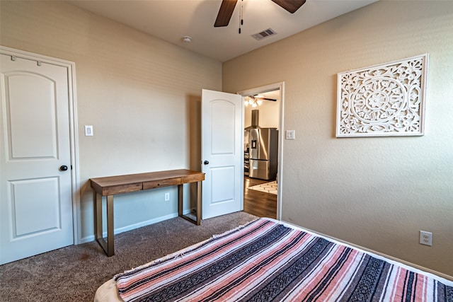 bedroom with stainless steel fridge with ice dispenser, ceiling fan, and carpet flooring