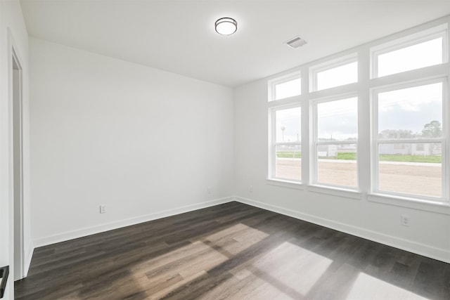 empty room with dark hardwood / wood-style floors