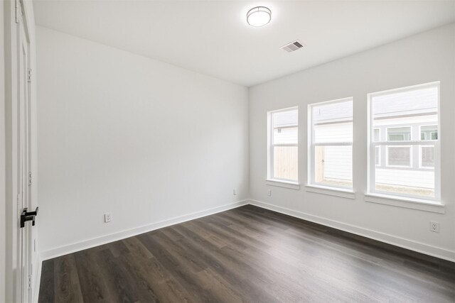 unfurnished room featuring dark hardwood / wood-style flooring