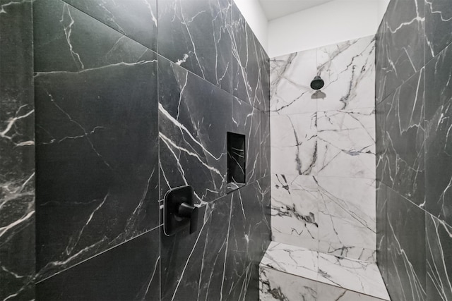 bathroom with a tile shower