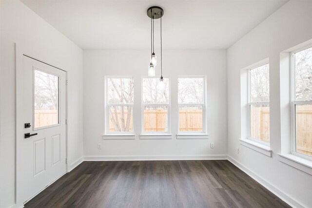 unfurnished dining area featuring dark hardwood / wood-style flooring