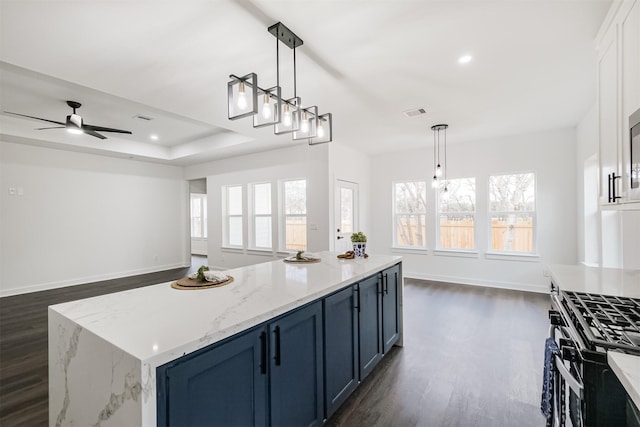 kitchen with hanging light fixtures, a center island, and blue cabinetry