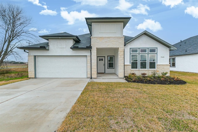 view of front of home with a garage and a front lawn