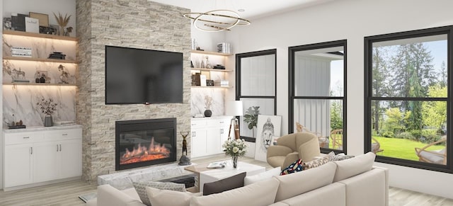 living room featuring light hardwood / wood-style flooring, a notable chandelier, and a fireplace