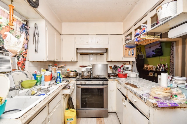 kitchen with ventilation hood, white cabinetry, backsplash, light hardwood / wood-style floors, and stainless steel gas range