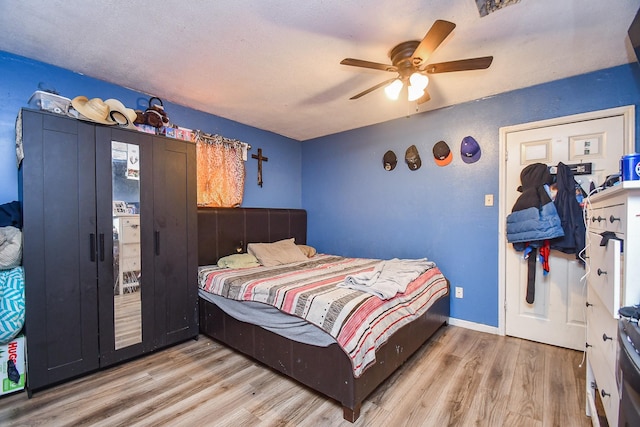 bedroom featuring ceiling fan and light wood-type flooring