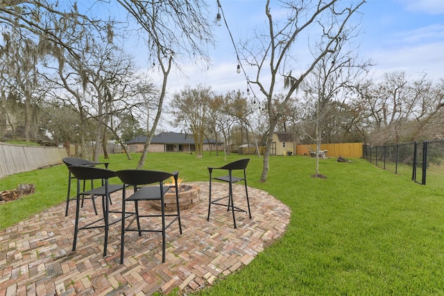 view of yard with a storage shed, a patio, and an outdoor fire pit