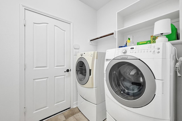 laundry room with light tile patterned flooring and independent washer and dryer