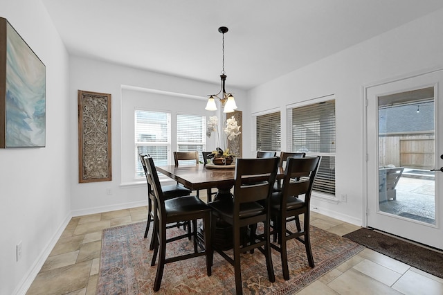 dining area featuring an inviting chandelier