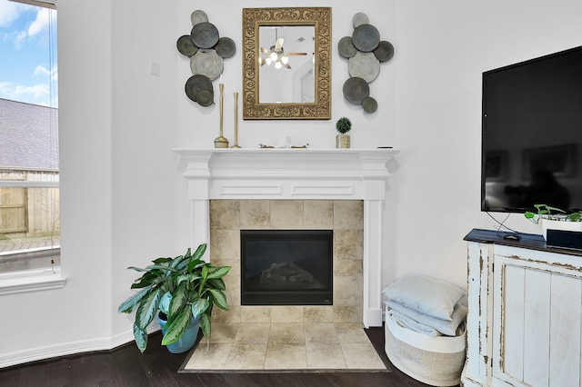 living room with hardwood / wood-style floors and a tile fireplace