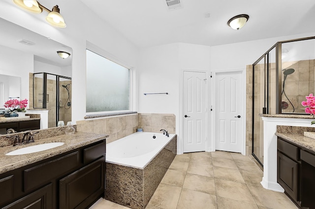 bathroom with shower with separate bathtub, vanity, and tile patterned floors