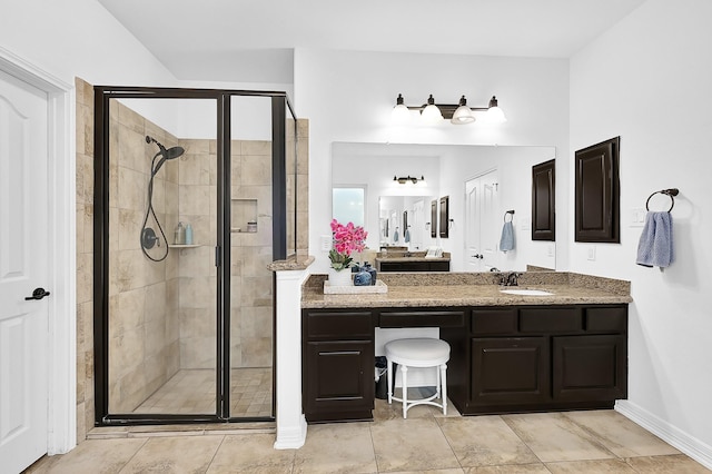 bathroom featuring vanity and a shower with door