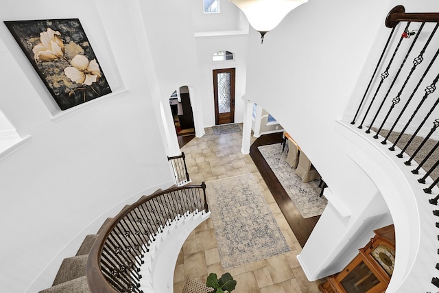 foyer entrance featuring a towering ceiling