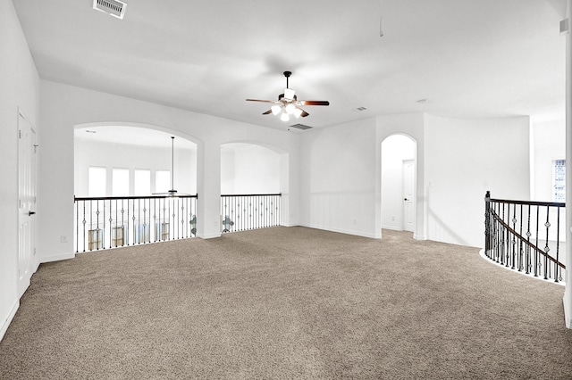 carpeted spare room featuring ceiling fan