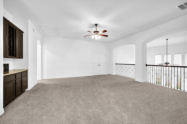 carpeted empty room with ceiling fan