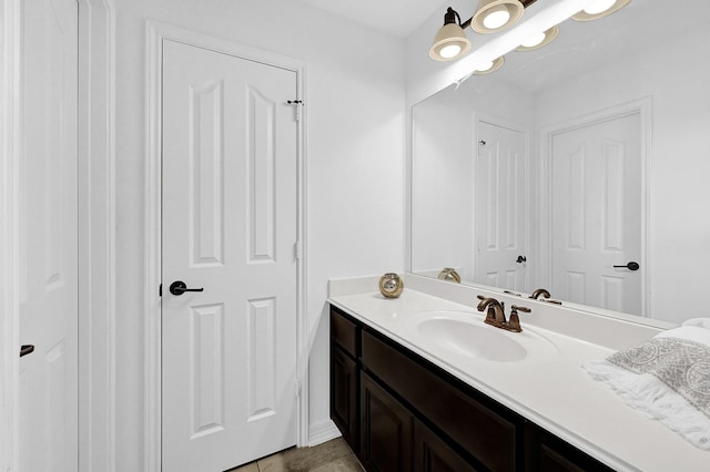 bathroom with tile patterned flooring and vanity